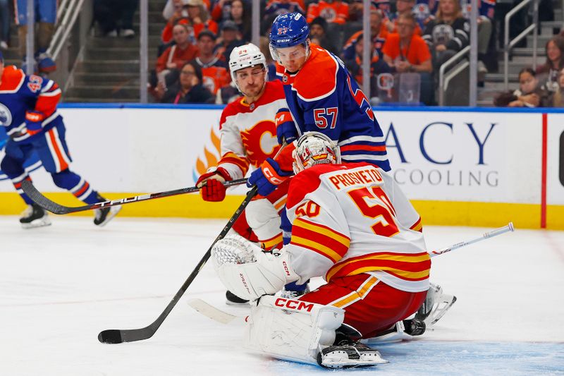 Sep 21, 2025; Edmonton, Alberta, CAN; Edmonton Oilers forward Viljami Marjala (57) looks for a loose puck in front of Calgary Flames goaltender Ivan Prosvetov (50) during the third period at Rogers Place. Mandatory Credit: Perry Nelson-Imagn Images