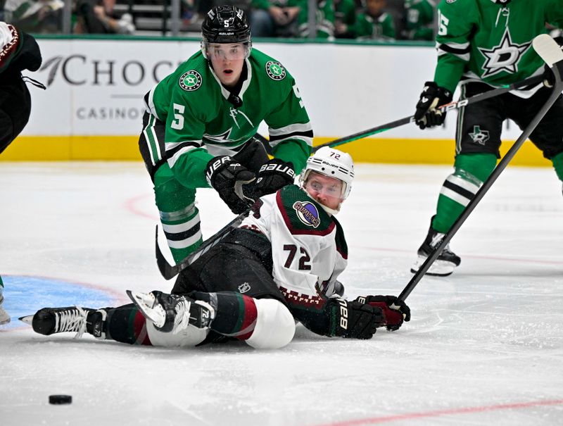 Nov 14, 2023; Dallas, Texas, USA; Dallas Stars defenseman Nils Lundkvist (5) and Arizona Coyotes center Travis Boyd (72) look for the puck in the Dallas zone during the third period at the American Airlines Center. Mandatory Credit: Jerome Miron-USA TODAY Sports