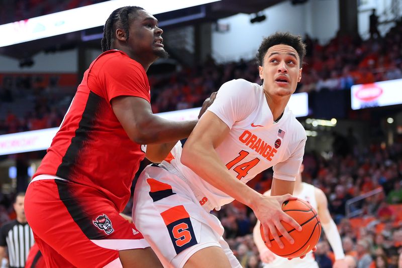 Feb 14, 2023; Syracuse, New York, USA; Syracuse Orange center Jesse Edwards (14) drives to the basket as North Carolina State Wolfpack forward D.J. Burns Jr. (30) defends during the first half at the JMA Wireless Dome. Mandatory Credit: Rich Barnes-USA TODAY Sports