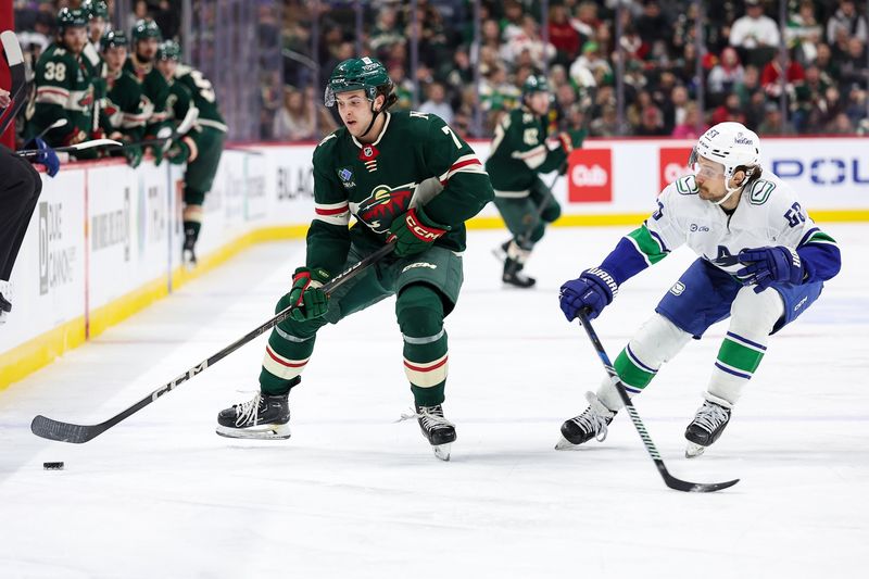 Dec 3, 2024; Saint Paul, Minnesota, USA; Minnesota Wild defenseman Brock Faber (7) skates with the puck as Vancouver Canucks center Teddy Blueger (53) defends during the third period at Xcel Energy Center. Mandatory Credit: Matt Krohn-Imagn Images