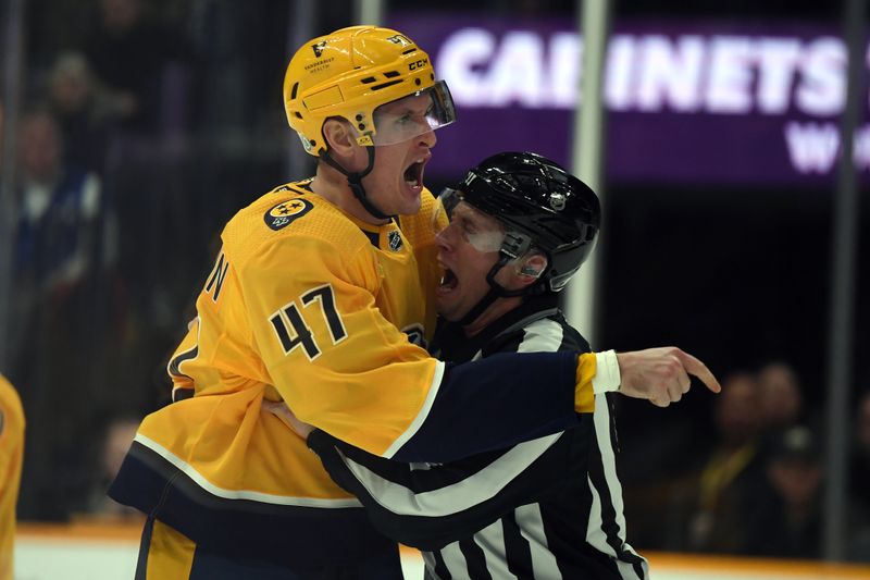 Dec 19, 2023; Nashville, Tennessee, USA; Nashville Predators right wing Michael McCarron (47) is held back by linesman Libor Suchanek (60) before receiving a game misconduct during the first period against the Vancouver Canucks at Bridgestone Arena. Mandatory Credit: Christopher Hanewinckel-USA TODAY Sports