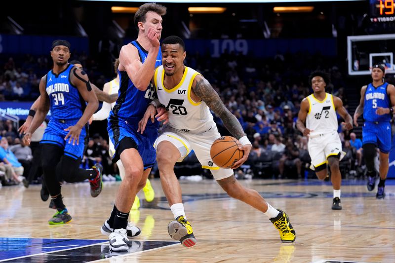 ORLANDO, FLORIDA - FEBRUARY 29: Franz Wagner #22 of the Orlando Magic fouls John Collins #20 of the Utah Jazz during the third quarter at Kia Center on February 29, 2024 in Orlando, Florida. NOTE TO USER: User expressly acknowledges and agrees that, by downloading and or using this photograph, user is consenting to the terms and conditions of the Getty Images License Agreement. (Photo by Rich Storry/Getty Images)