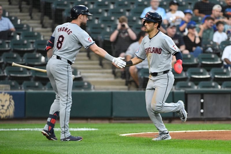 Sep 9, 2024; Chicago, Illinois, USA;  Cleveland Guardians outfielder Steven Kwan (38) high fives outfielder Lane Thomas (8) after he scored against the Chicago White Sox during the first inning at Guaranteed Rate Field. Mandatory Credit: Matt Marton-Imagn Images