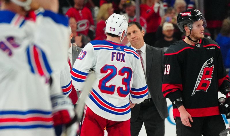 May 16, 2024; Raleigh, North Carolina, USA; Carolina Hurricanes head coach Rod Brind’Amour shake hands with New York Rangers defenseman Adam Fox (23) after the Rangers win in game six of the second round of the 2024 Stanley Cup Playoffs at PNC Arena. Mandatory Credit: James Guillory-USA TODAY Sports