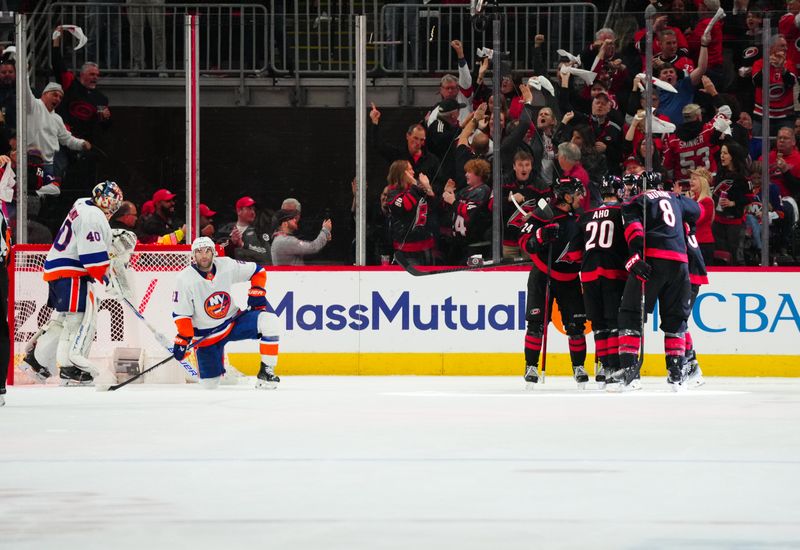 Apr 22, 2024; Raleigh, North Carolina, USA; Carolina Hurricanes left wing Teuvo Teravainen (86) celebrates his goal with center Sebastian Aho (20), center Seth Jarvis (24) and defenseman Brent Burns (8) against the New York Islanders during the second period in game two of the first round of the 2024 Stanley Cup Playoffs at PNC Arena. Mandatory Credit: James Guillory-USA TODAY Sports