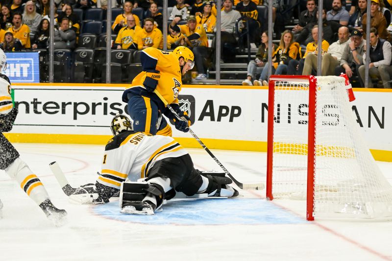 Oct 22, 2024; Nashville, Tennessee, USA;  Boston Bruins goaltender Jeremy Swayman (1) blocks the shot of Nashville Predators defenseman Jeremy Lauzon (3) during the first period at Bridgestone Arena. Mandatory Credit: Steve Roberts-Imagn Images