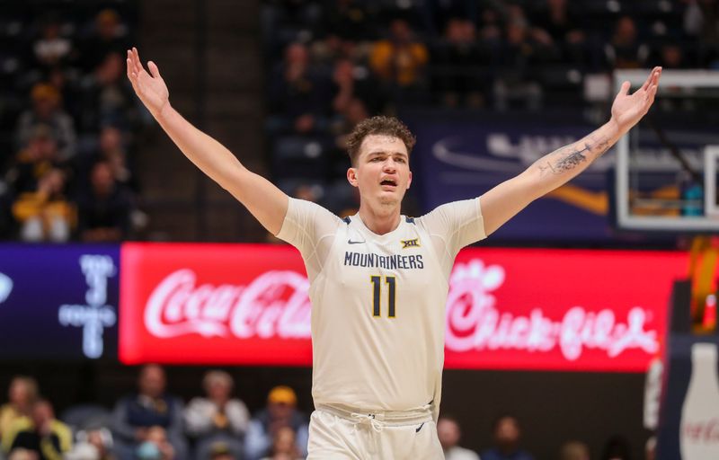 Jan 9, 2024; Morgantown, West Virginia, USA; West Virginia Mountaineers forward Quinn Slazinski (11) celebrates during the second half against the Kansas State Wildcats at WVU Coliseum. Mandatory Credit: Ben Queen-USA TODAY Sports