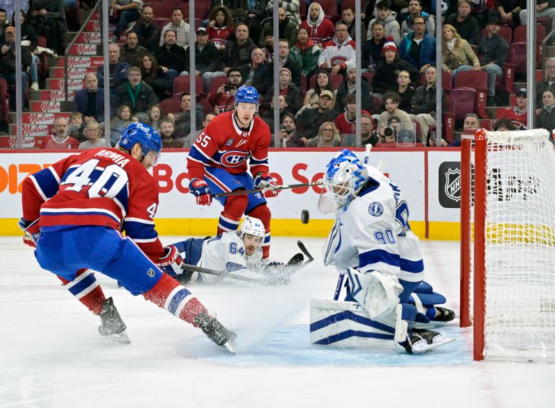 Nov 7, 2023; Montreal, Quebec, CAN; Tampa Bay Lightning goalie Matt Tomkins (90) stops Montreal forward Michael Pezzetta (55) during the first period at the Bell Centre. Mandatory Credit: Eric Bolte-USA TODAY Sports