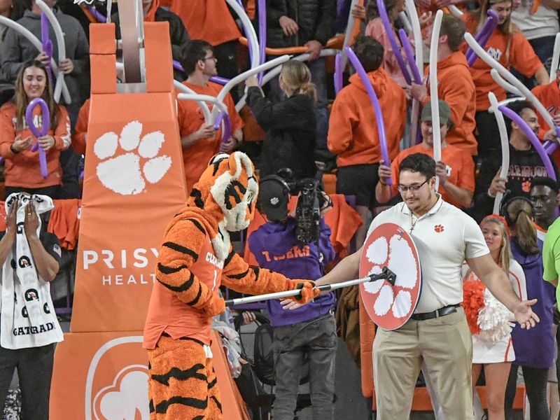 Jan 6, 2024; Clemson, South Carolina, USA; The Clemson Tiger pretends to clean the shirt of the usual floor mopper at a break in the game with North Carolina during the second half  at Littlejohn Coliseum. Mandatory Credit: Ken Ruinard-USA TODAY Sports