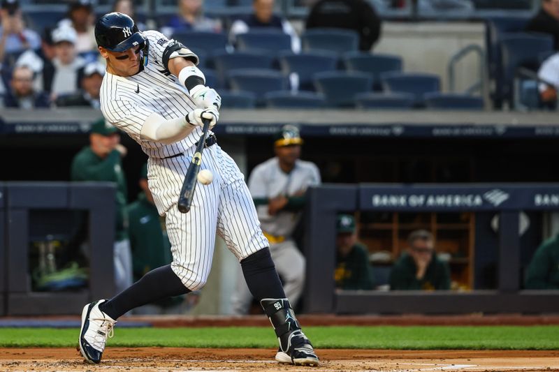 Apr 24, 2024; Bronx, New York, USA; New York Yankees center fielder Aaron Judge (99) hits a two run home run in the first inning against the Oakland Athletics at Yankee Stadium. Mandatory Credit: Wendell Cruz-USA TODAY Sports