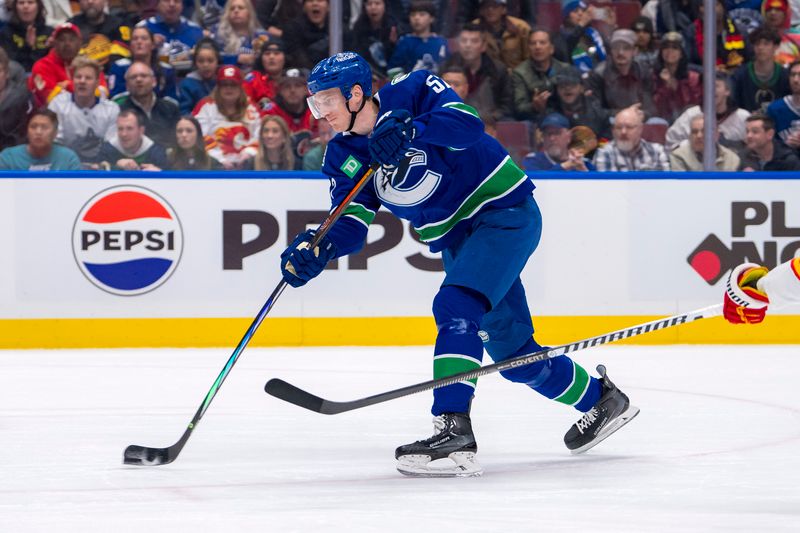 Apr 16, 2024; Vancouver, British Columbia, CAN; Vancouver Canucks defenseman Tyler Myers (57) shoots on a shorthanded breakaway against the Calgary Flames in the first period at Rogers Arena. Mandatory Credit: Bob Frid-USA TODAY Sports