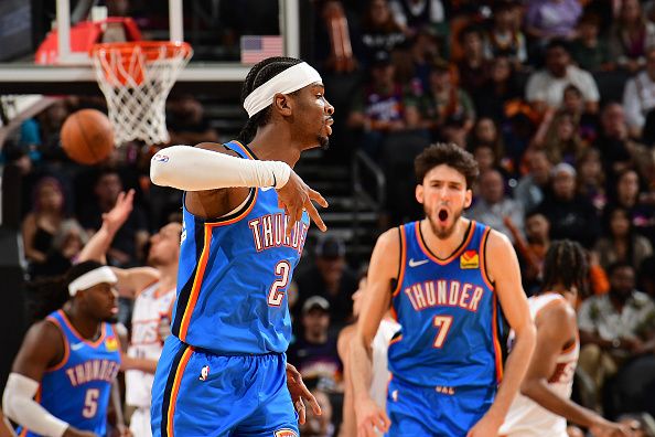 PHOENIX, AZ - NOVEMBER  12:  Shai Gilgeous-Alexander #2 and Chet Holmgren #7 of the Oklahoma City Thunder react during the game against the Phoenix Suns on November 12, 2023 at Footprint Center in Phoenix, Arizona. NOTE TO USER: User expressly acknowledges and agrees that, by downloading and or using this photograph, user is consenting to the terms and conditions of the Getty Images License Agreement. Mandatory Copyright Notice: Copyright 2023 NBAE (Photo by Kate Frese/NBAE via Getty Images)