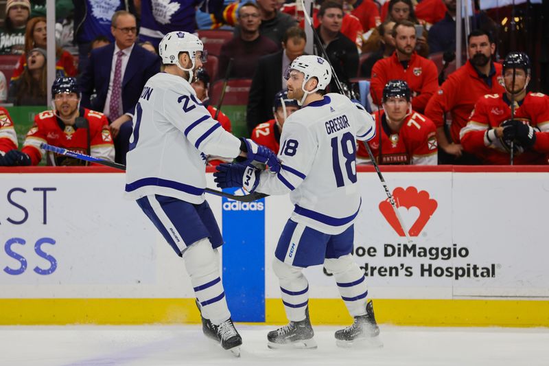 Apr 16, 2024; Sunrise, Florida, USA; Toronto Maple Leafs center Noah Gregor (18) celebrates with defenseman Joel Edmundson (20) after scoring against the Florida Panthers during the first period at Amerant Bank Arena. Mandatory Credit: Sam Navarro-USA TODAY Sports