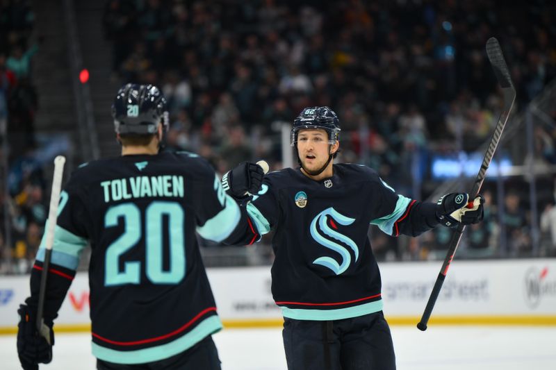 Jan 19, 2026; Seattle, Washington, USA; Seattle Kraken defenseman Brandon Montour (62) celebrates with right wing Eeli Tolvanen (20) after Tolvanen scored a goal against the Pittsburgh Penguins during the third period at Climate Pledge Arena. Mandatory Credit: Steven Bisig-Imagn Images