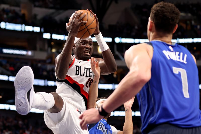 DALLAS, TEXAS - JANUARY 05: Duop Reath #26 of the Portland Trail Blazers grabs a rebound against Dwight Powell #7 of the Dallas Mavericks in the first half at American Airlines Center on January 05, 2024 in Dallas, Texas. NOTE TO USER: User expressly acknowledges and agrees that, by downloading and or using this photograph, User is consenting to the terms and conditions of the Getty Images License Agreement. (Photo by Tim Heitman/Getty Images)