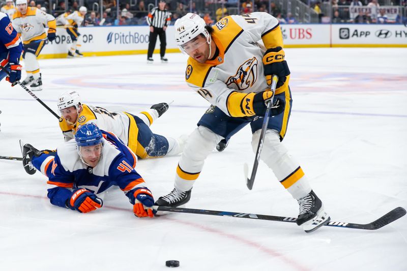 Apr 6, 2024; Elmont, New York, USA; Nashville Predators left wing Kiefer Sherwood (44) skates the puck past New York Islanders defenseman Robert Bortuzzo (41) during the third period at UBS Arena. Mandatory Credit: Tom Horak-USA TODAY Sports