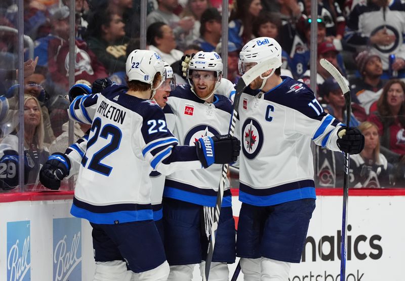 Apr 28, 2024; Denver, Colorado, USA; Members of the Winnipeg Jet celebrate a goal scored during the first period against the Colorado Avalanche in game four of the first round of the 2024 Stanley Cup Playoffs at Ball Arena. Mandatory Credit: Ron Chenoy-USA TODAY Sports