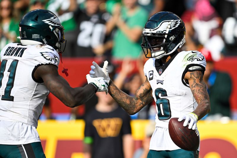 Philadelphia Eagles wide receiver DeVonta Smith (6) celebrates his touchdown catch with wide receiver A.J. Brown (11) during the second half of an NFL football game against the Washington Commanders, Sunday, Oct. 29, 2023, in Landover, Md. (AP Photo/Terrance Williams)