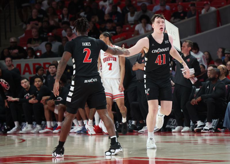 Mar 1, 2025; Houston, Texas, USA; Cincinnati Bearcats guard Jizzle James (2) celebrates guard Simas Lukosius (41) three point basket against the Cincinnati Bearcats in the first half at Fertitta Center. Mandatory Credit: Thomas Shea-Imagn Images