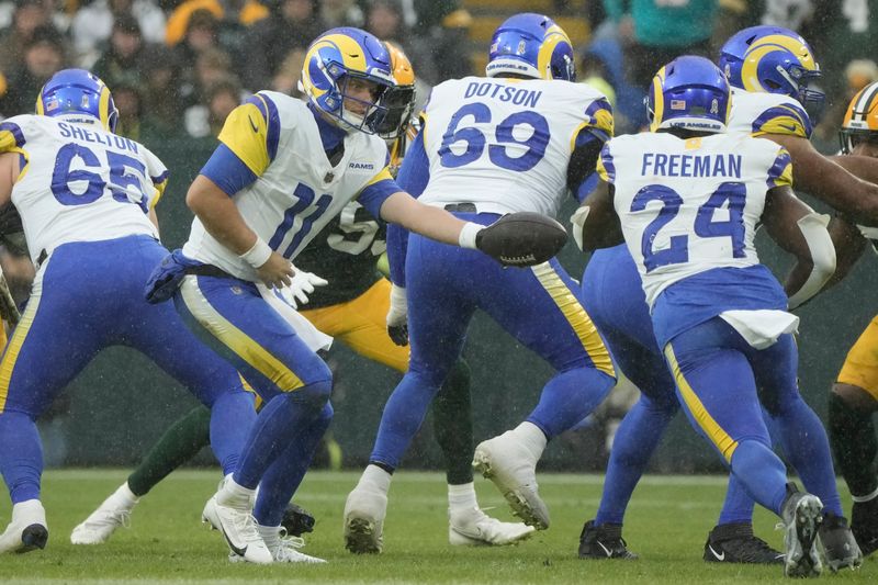 Los Angeles Rams' Brett Rypien hands off to Royce Freeman during the second half of an NFL football game against the Green Bay Packers Sunday, Nov. 5, 2023, in Green Bay, Wis. (AP Photo/Morry Gash)