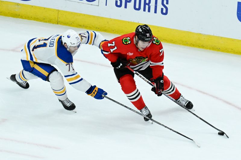 Oct 19, 2024; Chicago, Illinois, USA;  Chicago Blackhawks left wing Taylor Hall (71) and Buffalo Sabres center Ryan McLeod (71) chase the puck during the third period at the United Center. Mandatory Credit: Matt Marton-Imagn Images