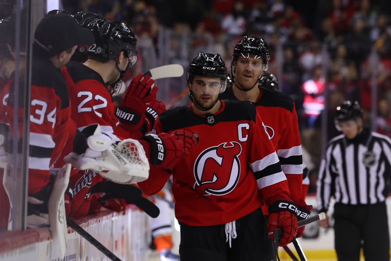 Oct 27, 2024; Newark, New Jersey, USA; New Jersey Devils center Nico Hischier (13) celebrates his goal against the Anaheim Ducks during the third period at Prudential Center. Mandatory Credit: Ed Mulholland-Imagn Images