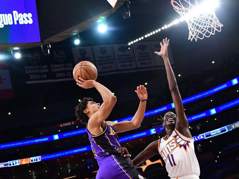 LOS ANGELES, CA - JANUARY 11: Max Christie #10 of the Los Angeles Lakers drives to the basket against Bol Bol #11 of the Phoenix Suns during the game on January 11, 2024 at Crypto.Com Arena in Los Angeles, California. NOTE TO USER: User expressly acknowledges and agrees that, by downloading and/or using this Photograph, user is consenting to the terms and conditions of the Getty Images License Agreement. Mandatory Copyright Notice: Copyright 2024 NBAE (Photo by Adam Pantozzi/NBAE via Getty Images)