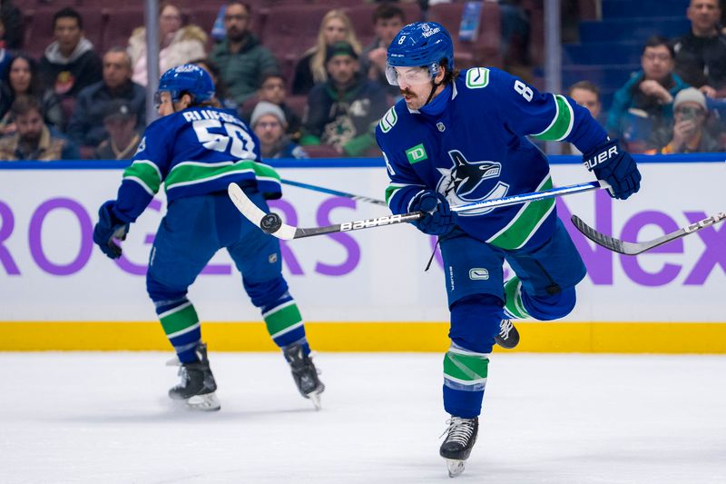 Nov 17, 2024; Vancouver, British Columbia, CAN; Vancouver Canucks forward Conor Garland (8) knocks down a flying puck against the Nashville Predators during the first period at Rogers Arena. Mandatory Credit: Bob Frid-Imagn Images