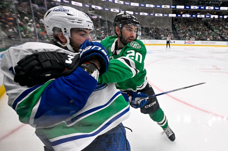 Jan 31, 2025; Dallas, Texas, USA; Dallas Stars defenseman Kyle Capobianco (20) holds back Vancouver Canucks right wing Conor Garland (8) during the third period at the American Airlines Center. Mandatory Credit: Jerome Miron-Imagn Images