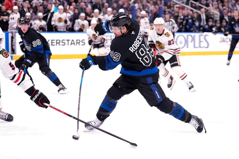 Dec 2, 2024; Toronto, Ontario, CAN; Toronto Maple Leafs forward Nicholas Robertson (89) shoots the puck against the Chicago Blackhawks during the first period at Scotiabank Arena. Mandatory Credit: John E. Sokolowski-Imagn Images