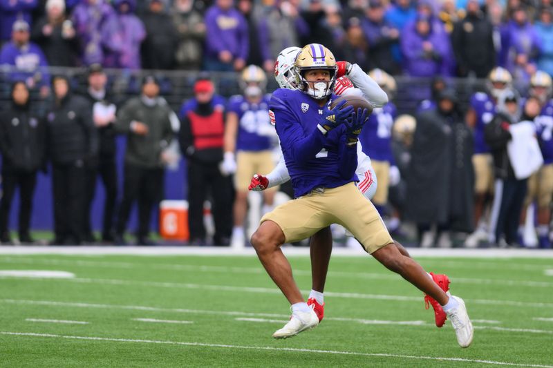 Nov 11, 2023; Seattle, Washington, USA; Washington Huskies wide receiver Rome Odunze (1) catches a pass over Utah Utes cornerback Miles Battle (1) during the second half at Alaska Airlines Field at Husky Stadium. Mandatory Credit: Steven Bisig-USA TODAY Sports