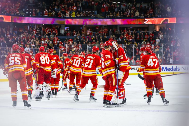 Feb 22, 2024; Calgary, Alberta, CAN; Calgary Flames players celebrates win over Boston Bruins in the overtime period at Scotiabank Saddledome. Mandatory Credit: Sergei Belski-USA TODAY Sports