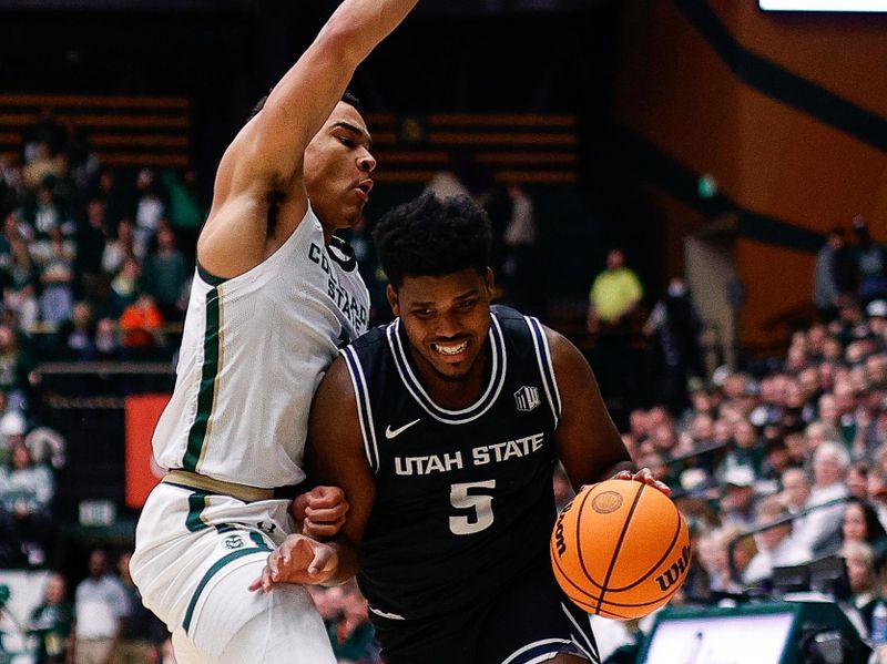 Feb 4, 2023; Fort Collins, Colorado, USA; Utah State Aggies guard RJ Eytle-Rock (5) controls the ball under pressure from Colorado State Rams guard John Tonje (1) in the first half at Moby Arena. Mandatory Credit: Isaiah J. Downing-USA TODAY Sports