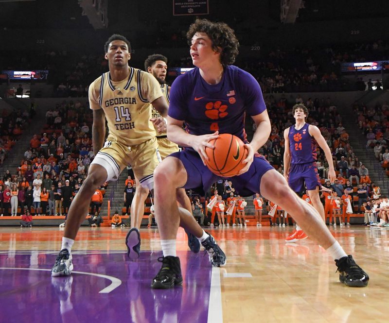 Jan 24, 2023; Clemson, South Carolina, USA; Clemson Tigers forward Ian Schieffelin (4) moves to the basket against Georgia Tech Yellow Jackets forward Jalon Moore (14)  during the second half at Littlejohn Coliseum. Mandatory Credit: Ken Ruinard-USA TODAY Sports