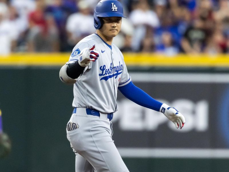 May 9, 2025; Phoenix, Arizona, USA; Los Angeles Dodgers designated hitter Shohei Ohtani reacts after hitting a double in the second inning against the Arizona Diamondbacks at Chase Field. Mandatory Credit: Mark J. Rebilas-Imagn Images