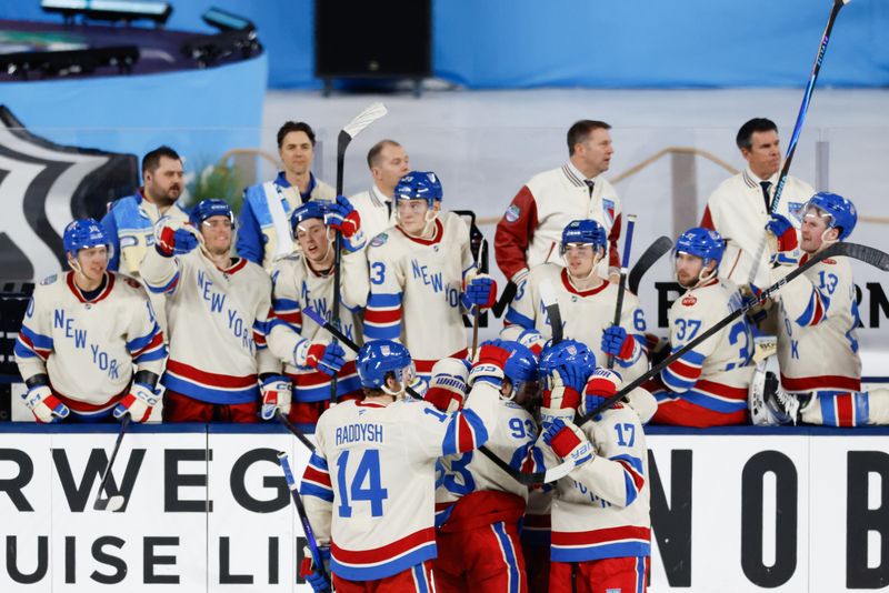 Jan 2, 2026; Miami, Florida, USA; New York Rangers center Mika Zibanejad (93) celebrates with teammates after scoring an empty net goal for his third of the game against the Florida Panthers during the third period in the 2026 Winter Classic ice hockey game at loanDepot Park. Mandatory Credit: Rhona Wise-Imagn Images