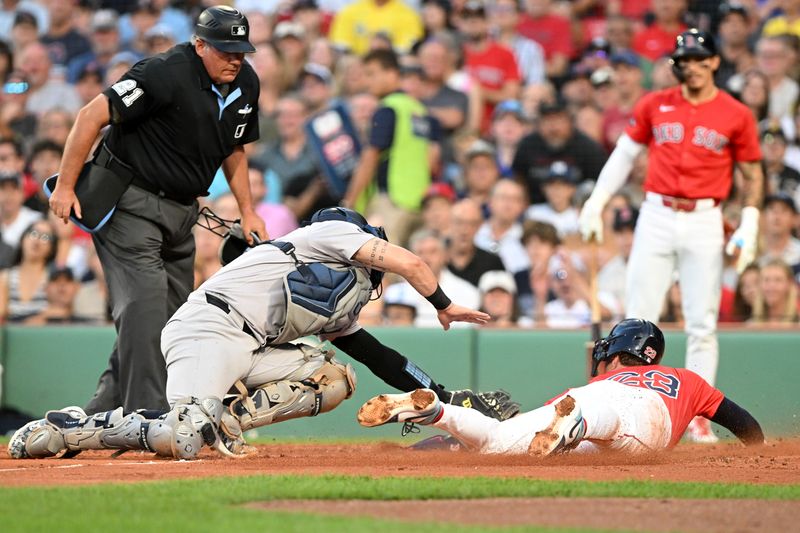 Jul 26, 2024; Boston, Massachusetts, USA;  New York Yankees catcher Austin Wells (28) tags Boston Red Sox shortstop Romy Gonzalez (23) out at home during the second inning at Fenway Park. Mandatory Credit: Brian Fluharty-USA TODAY Sports