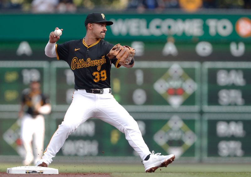 May 22, 2024; Pittsburgh, Pennsylvania, USA;  Pittsburgh Pirates second baseman Nick Gonzales (39) throws to first base to complete a double play against the San Francisco Giants during the second inning at PNC Park. Mandatory Credit: Charles LeClaire-USA TODAY Sports