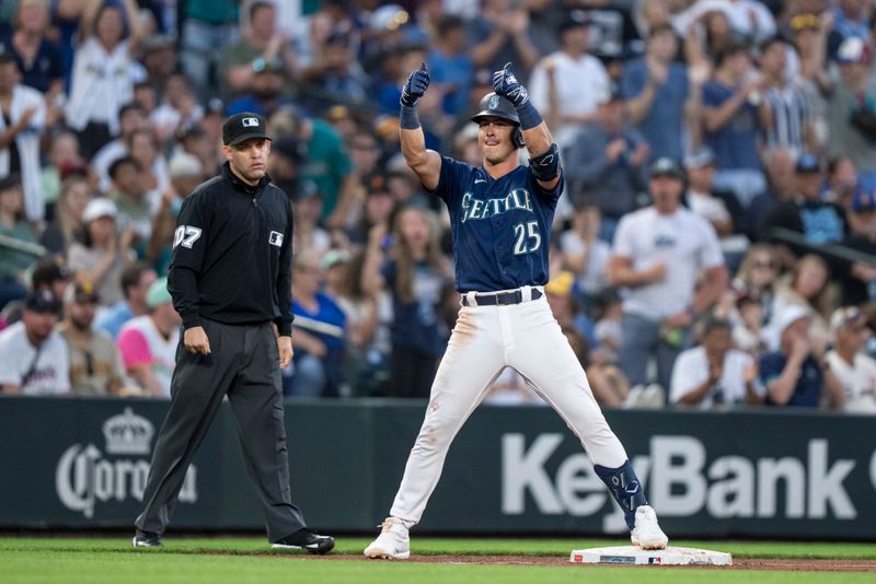 Aug 8, 2023; Seattle, Washington, USA; Seattle Mariners second baseman Dylan Moore (25) celebrates at third base after hitting an RBI-triple during the sixth inning against the San Diego Padres at T-Mobile Park. Mandatory Credit: Stephen Brashear-USA TODAY Sports