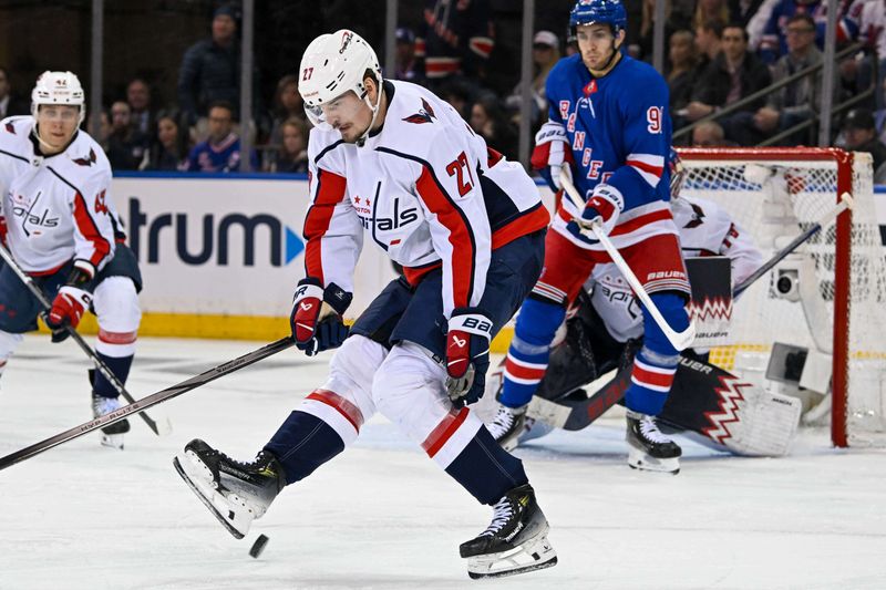 Apr 23, 2024; New York, New York, USA;  Washington Capitals defenseman Alexander Alexeyev (27) blocks a shot with his skate against the New York Rangers during the third period in game two of the first round of the 2024 Stanley Cup Playoffs at Madison Square Garden. Mandatory Credit: Dennis Schneidler-USA TODAY Sports