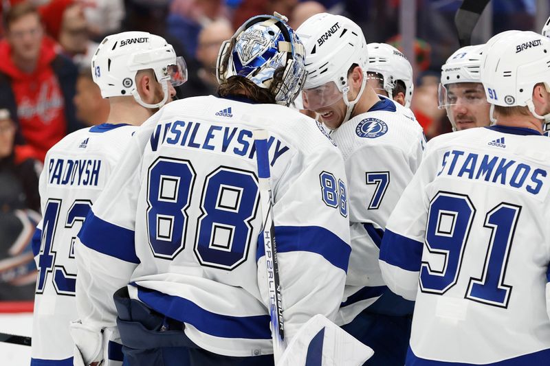 Dec 23, 2023; Washington, District of Columbia, USA; Tampa Bay Lightning goaltender Andrei Vasilevskiy (88) celebrates with Lightning defenseman Haydn Fleury (7) after their game against the Washington Capitals at Capital One Arena. Mandatory Credit: Geoff Burke-USA TODAY Sports