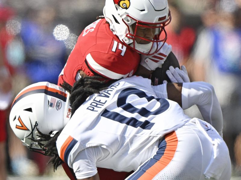 Oct 4, 2025; Louisville, Kentucky, USA; Virginia Cavaliers defensive back Ja'son Prevard (10) tackles Louisville Cardinals wide receiver Kris Hughes (14) during the first quarter at L&N Federal Credit Union Stadium. Mandatory Credit: Jamie Rhodes-Imagn Images