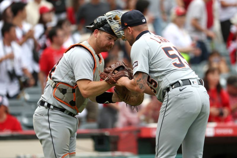 Sep 17, 2023; Anaheim, California, USA;  Detroit Tigers catcher Jake Rogers (34) and relief pitcher Alex Lange (55) celebrate a victory after defeating the Los Angeles Angels 5-3 at Angel Stadium. Mandatory Credit: Kiyoshi Mio-USA TODAY Sports