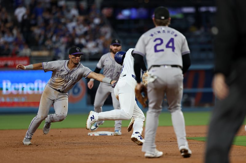 Jun 1, 2024; Los Angeles, California, USA;  Colorado Rockies shortstop Ezequiel Tovar (14) tags Los Angeles Dodgers designated hitter Shohei Ohtani (17) out on a pick off play during the third inning at Dodger Stadium. Mandatory Credit: Kiyoshi Mio-USA TODAY Sports