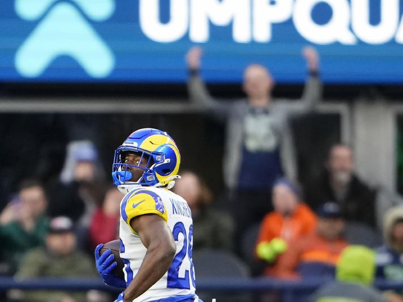 Los Angeles Rams safety Kamren Kinchens returns an interception for a touchdown during the second half of an NFL football game against the Seattle Seahawks in Seattle, Sunday, Nov. 3, 2024. (AP Photo/Lindsey Wasson)