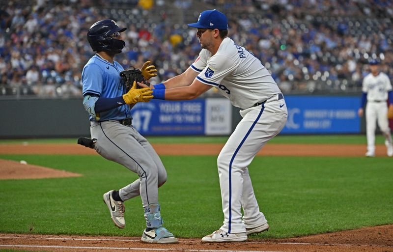 Jul 2, 2024; Kansas City, Missouri, USA;  Kansas City Royals first baseman Vinnie Pasquantino (9) tags out Tampa Bay Rays second baseman Richie Palacios (1) in the first base line in the fourth inning at Kauffman Stadium. Mandatory Credit: Peter Aiken-USA TODAY Sports