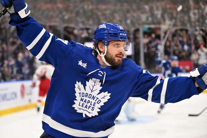 Dec 30, 2023; Toronto, Ontario, CAN; Toronto Maple Leafs defenseman Timothy Liljegren (37) celebrates after scoring against the Carolina Hurricanes in the third period at Scotiabank Arena. Mandatory Credit: Dan Hamilton-USA TODAY Sports