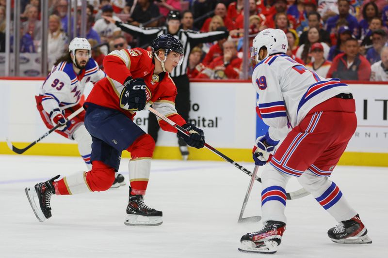 May 26, 2024; Sunrise, Florida, USA; Florida Panthers center Anton Lundell (15) shoots the puck against the New York Rangers during the first period in game three of the Eastern Conference Final of the 2024 Stanley Cup Playoffs at Amerant Bank Arena. Mandatory Credit: Sam Navarro-USA TODAY Sports