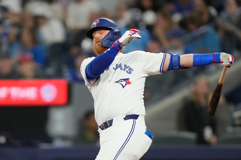 May 10, 2024; Toronto, Ontario, CAN; Toronto Blue Jays designated hitter Justin Turner (2) reacts after grounding out the Minnesota Twins shortstop Carlos Correa (not pictured) during the sixth inning at Rogers Centre. Mandatory Credit: John E. Sokolowski-USA TODAY Sports