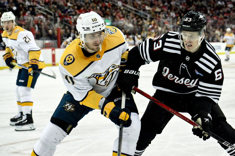 Apr 7, 2024; Newark, New Jersey, USA; Nashville Predators center Colton Sissons (10) and New Jersey Devils left wing Jesper Bratt (63) compete for the puck during the second period at Prudential Center. Mandatory Credit: John Jones-USA TODAY Sports